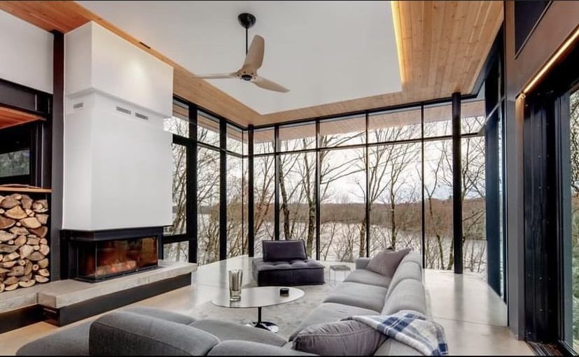 Finished concrete floor and poured concrete fireplace in a modern lakefront cottage