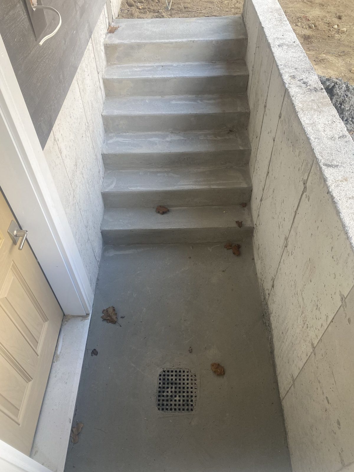Poured concrete walkout stairs with drain